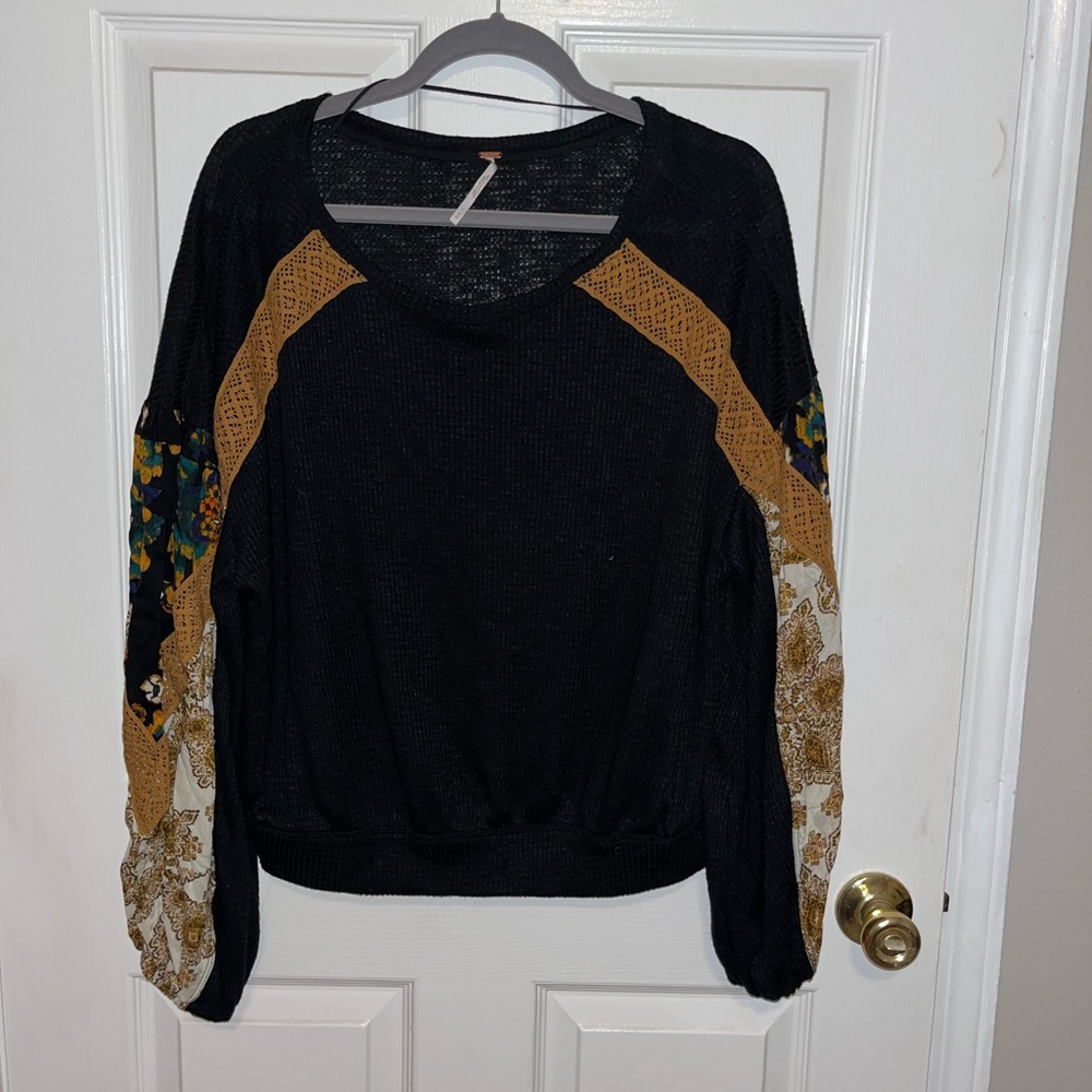 Black waffle thermal free people top with intricate designs on arms. NWOT